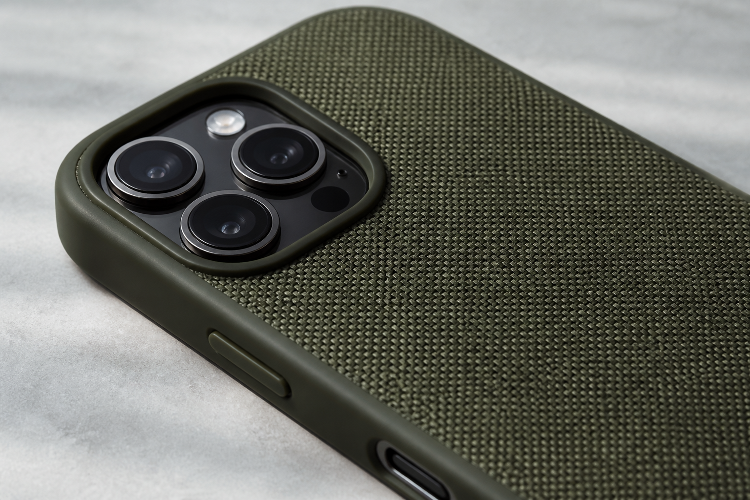 Close-up of the woven textile and raised iPhone 16 Pro Max camera surround